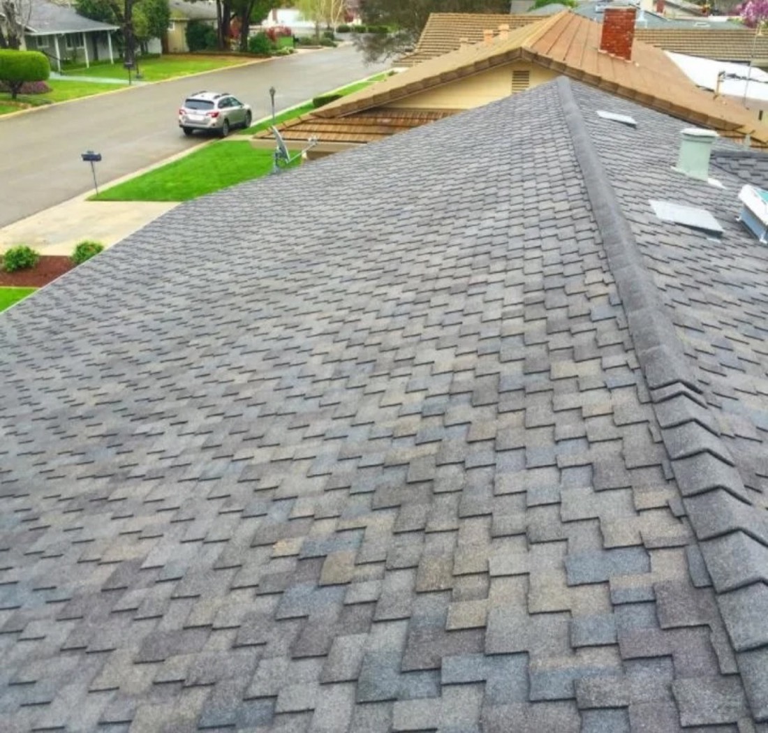 Aerial close-up of architectural asphalt shingle pattern installed by DeHart Roofing in Turlock