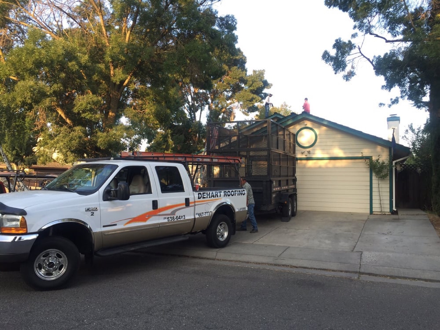 DeHart Roofing truck and crew on-site for a Central Valley residential roof replacement at end of day