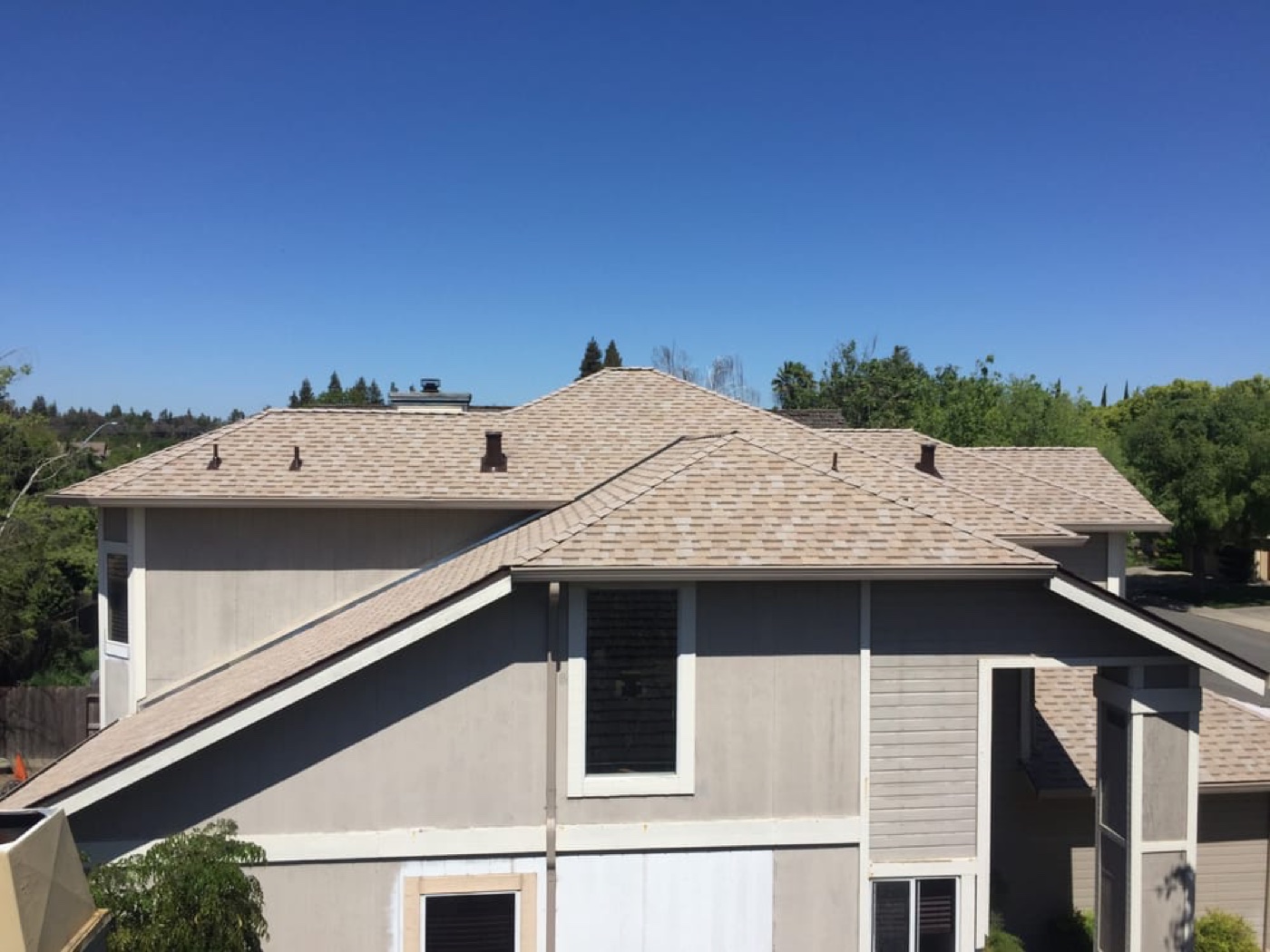 Two-story Salida home with cool-rated tan architectural asphalt shingles installed by DeHart Roofing
